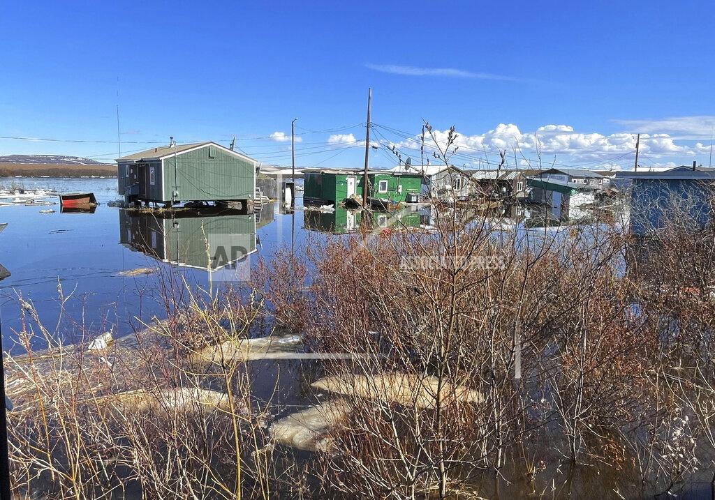 Nathan Hadley Jr. This photo provided by Nathan Hadley Jr. shows flooding in the village of Buckland, Alaska, on Thursday, May 13, 2021. An ice jam on the Buckland River, a half mile below the community, has caused the entire village of about 500 residents in northwest Alaska to be completely inundated. (Nathan Hadley Jr. via AP)