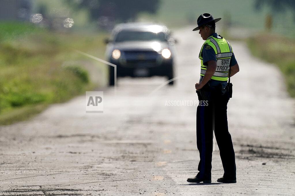 Charlie Riedel A Missouri state trooper controls traffic, Tuesday, June 28, 2022, on a road leading to the scene of an Amtrak train which derailed after striking a dump truck Monday near Mendon, Mo. (AP Photo/Charlie Riedel)