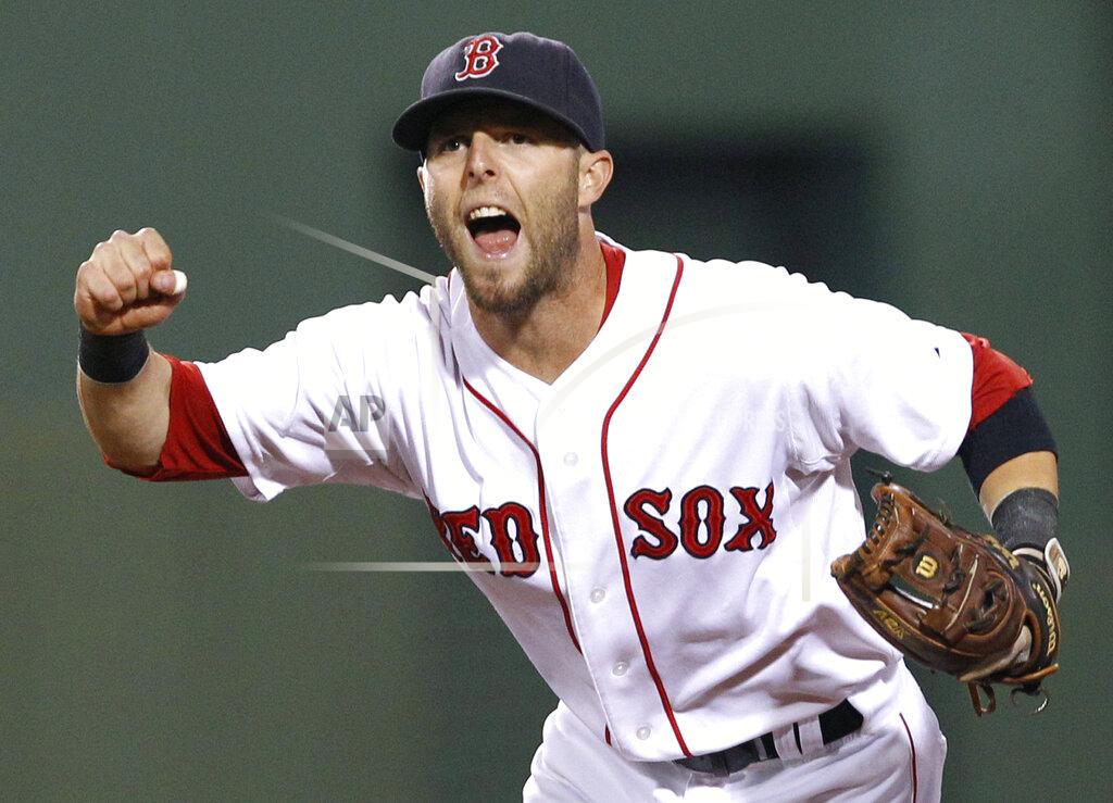 Elise Amendola FILE - In this Aug. 16, 2011, file photo, Boston Red Sox second baseman Dustin Pedroia celebrates the completion of a triple play against the Tampa Bay Rays during the fourth inning of the second baseball game of a doubleheader in Boston. Pedroia, who was the 2007 Rookie of the Year and the AL MVP in his second season, retired Monday, Feb. 1, 2021. (AP Photo/Elise Amendola, File)