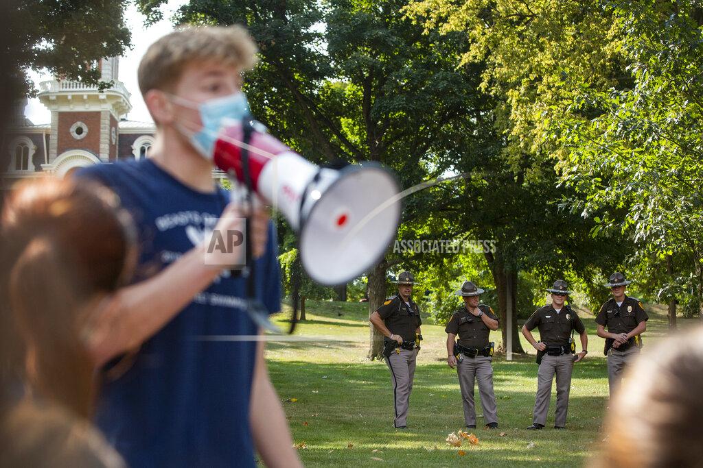 Olivia Sun Roosevelt High School swimmer and cross country runner Peter Swanda protests the cancellation of fall and winter extracurriculars on Sept. 7, 2020, in Des Moines, Iowa. All in-person activities were suspended this month as the district's classroom instruction remains virtual. (Olivia Sun/The Des Moines Register via AP)