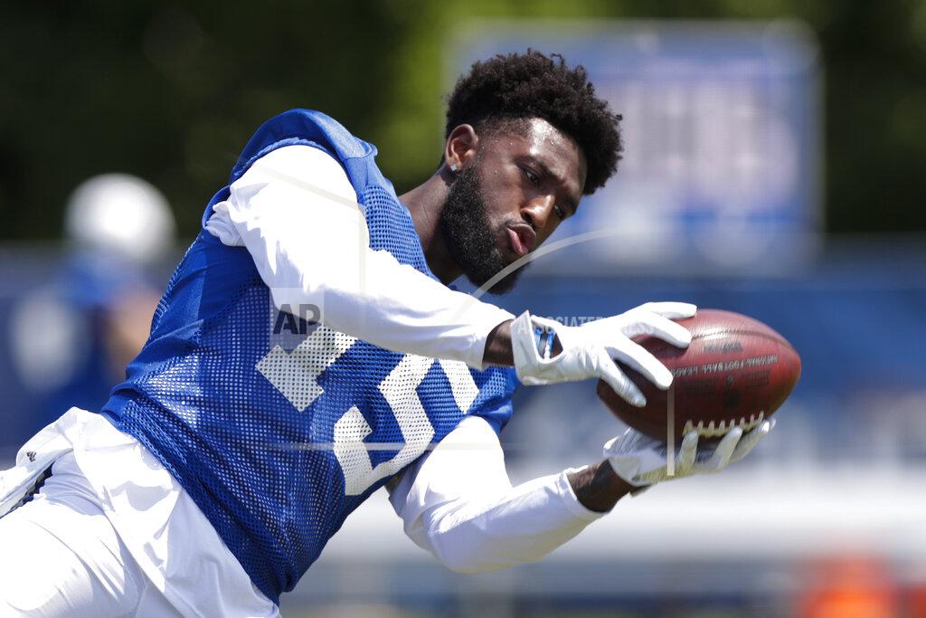 Luck returns to field as Colts open training camp workouts