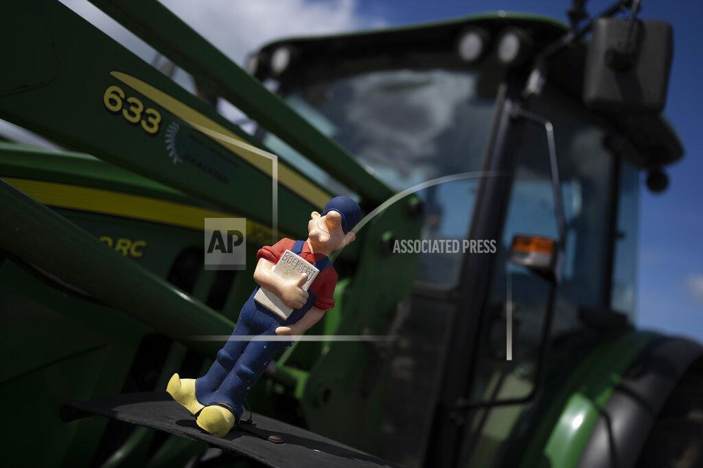Peter Dejong A puppet of a clog-wearing farmer sits atop a tractor at a blockade outside a distribution center for supermarket chain Aldi in the town of Drachten, northern Netherlands, Monday, July 4, 2022. Dutch farmers angry at government plans to slash emissions used tractors and trucks Monday to blockade supermarket distribution centers, the latest actions in a summer of discontent in the country's lucrative agricultural sector. (AP Photo/Peter Dejong)