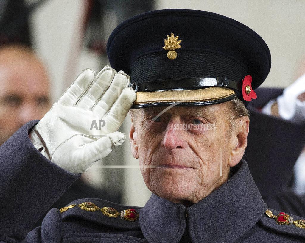 Paul Edwards FILE - In this file photo dated Monday, Nov. 11, 2013, Britain's Prince Philip salutes during a special Armistice Day ceremony under the Menin Gate in Ypres, Belgium. The Duke of Edinburgh attended a special Armistice Day ceremony on Monday to oversee the handover of 70 sandbags of soil from Flanders fields. The sandbags, collected by Belgian and British schoolchildren from Commonwealth cemeteries in Belgium, were handed over to the King's Troop Royal Horse Artillery and will be taken to London and placed in the Flanders Fields Memorial Garden at the Wellington Barracks. When Elizabeth became queen at the age of 25 in 1952, Philip gave up his naval career and dedicated himself to supporting her and the monarchy. Prince Philip who died Friday April 9, 2021, aged 99, lived through a tumultuous century of war and upheavals. (AP Photo/Paul Edwards, FILE)