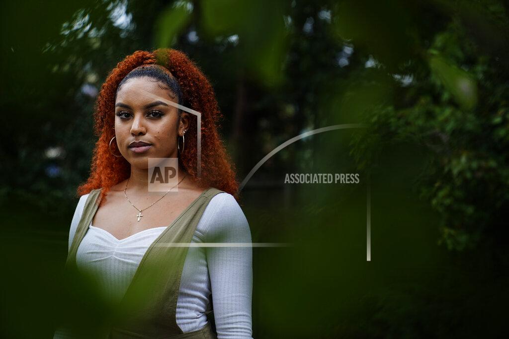 Brynn Anderson Olivia Musoke, 19, a direct descendant of a Pilgrim who came over on the Mayflower, poses for a portrait in Atlanta, on Friday, Sept 25, 2020. "Considering my ancestors helped incite the racial hierarchies that caused the need for these movements now, I do feel ashamed that that had to be part of history," said Musoke, whose ancestor on her mother's side arrived in America on the Mayflower. Musoke, whose father is Black, said the pride she feels in coming from people who helped settle this country "gets diminished by the role they played in kind of manipulating and terrorizing people of color, which trickled down to the structures we have today." (AP Photo/Brynn Anderson)