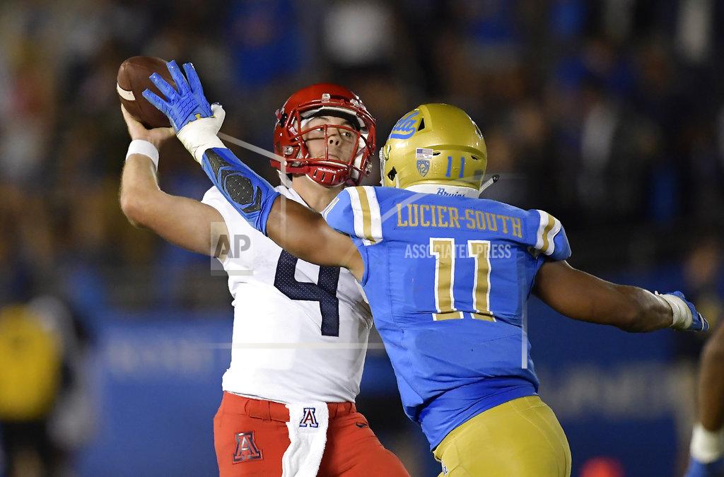 Mark J. Terrill Arizona quarterback Rhett Rodriguez, left, passes while under pressure from UCLA linebacker Keisean Lucier-South during the second half of an NCAA college football game Saturday, Oct. 20, 2018, in Pasadena, Calif. UCLA won 31-30. (AP Photo/Mark J. Terrill)