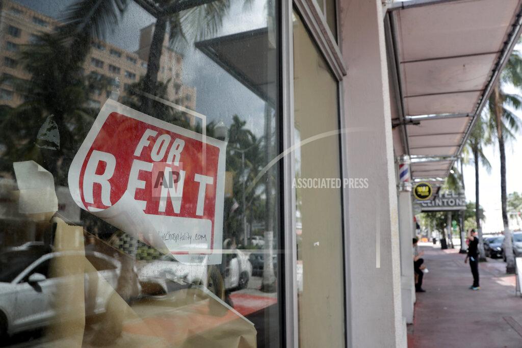 FILE - In this July 13, 2020 file photo, a For Rent sign hangs on a closed shop during the coronavirus pandemic in Miami Beach, Fla. Having endured what was surely a record-shattering slump last quarter, the U.S. economy faces a dim outlook as a resurgent coronavirus intensifies doubts about the likelihood of any sustained recovery the rest of the year. (AP Photo/Lynne Sladky)