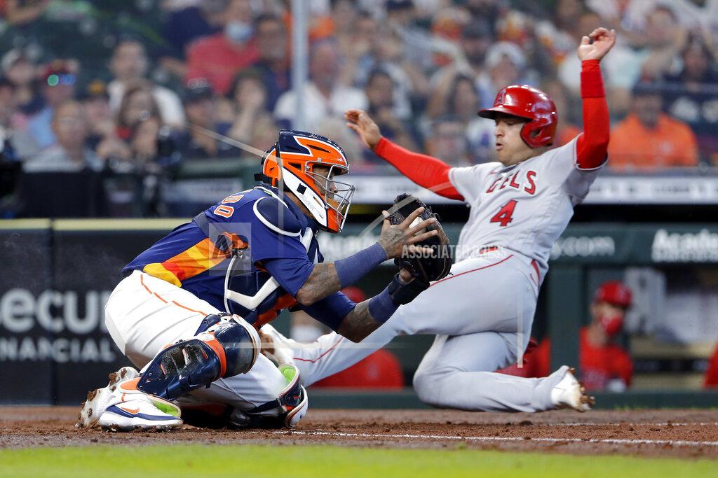 Michael Wyke Houston Astros catcher Martin Maldonado, left, tries to make the tag against Los Angeles Angels' Jose Iglesias (4) as he safely slides into home plate during the fifth inning of a baseball game Sunday, April 25, 2021, in Houston. (AP Photo/Michael Wyke)