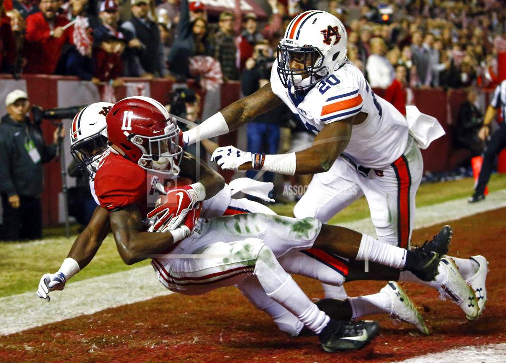 Butch Dill Alabama wide receiver Henry Ruggs III (11) catches a pass for a touchdown as Auburn defensive back Roger McCreary (17) and linebacker Cameron Latu (20) defend during the second half of an NCAA college football game Saturday, Nov. 24, 2018, in Tuscaloosa, Ala. (AP Photo/Butch Dill)