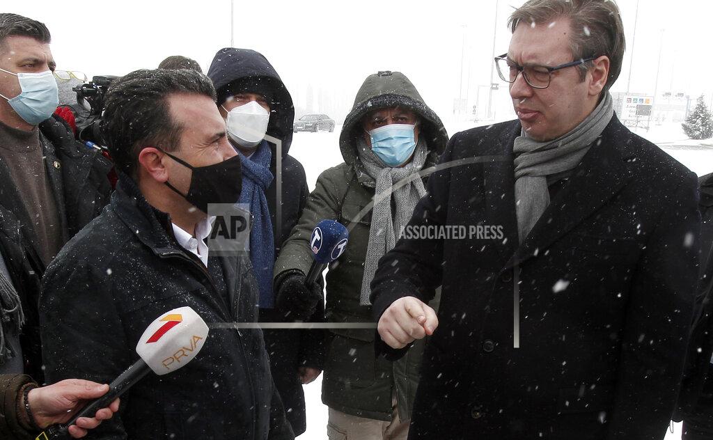 Boris Grdanoski Serbia's President Aleksandar Vucic, right, talks to North Macedonia's Prime Minister Zoran Zaev, left, during the handover of COVID-19 vaccines, at the border crossing Tabanovce, between North Macedonia and Serbia, on Sunday, Feb. 14, 2021. Serbia which has launched a successful vaccination campaign has donated some 8,000 doses of Pfizer COVID-19 shots to North Macedonia which is yet to deliver its first shots. (AP Photo/Boris Grdanoski)