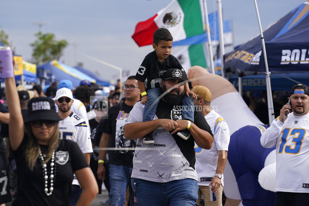 Marcio Jose Sanchez Fans for the Los Angeles Chargers and the Las Vegas Raiders tailgate in front of SoFi stadium before an NFL football game, Monday, Oct. 4, 2021, in Inglewood, Calif. (AP Photo/Marcio Jose Sanchez)