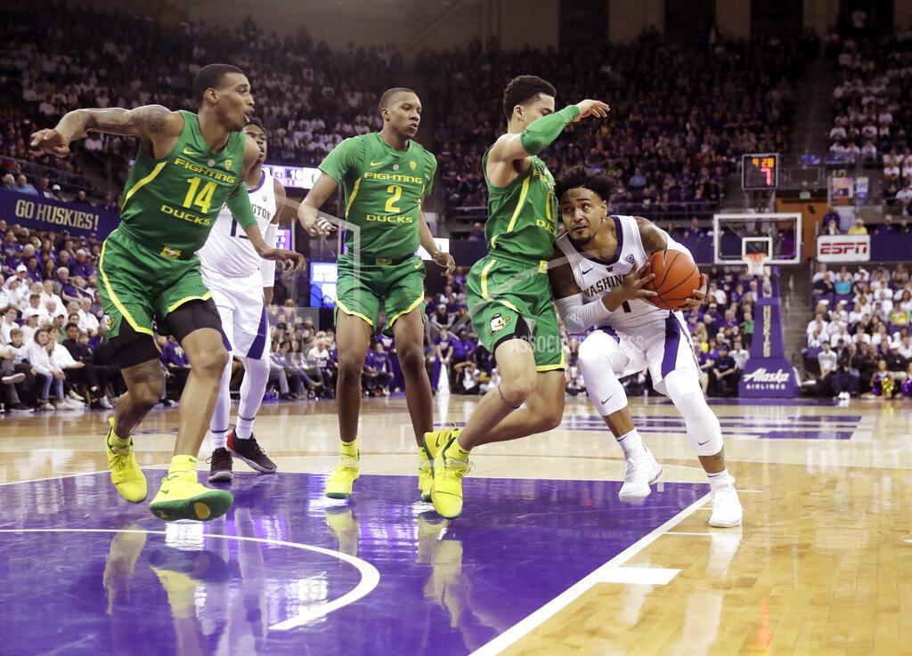Ted S. Warren Washington guard David Crisp, right, is blocked by Oregon guard Will Richardson, second from right, as Oregon's Kenny Wooten (14) and Louis King, (2) watch during the first half of an NCAA college basketball game, Saturday, March 9, 2019, in Seattle. (AP Photo/Ted S. Warren)