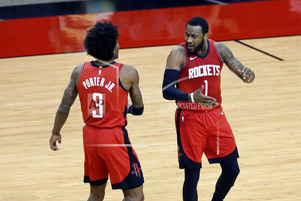 Michael Wyke Houston Rockets guard Kevin Porter Jr. (3) and guard John Wall (1) celebrate after Wall scored in the final minute of the team's NBA basketball game against the Dallas Mavericks on Wednesday, April 7, 2021, in Houston. (AP Photo/Michael Wyke, Pool)