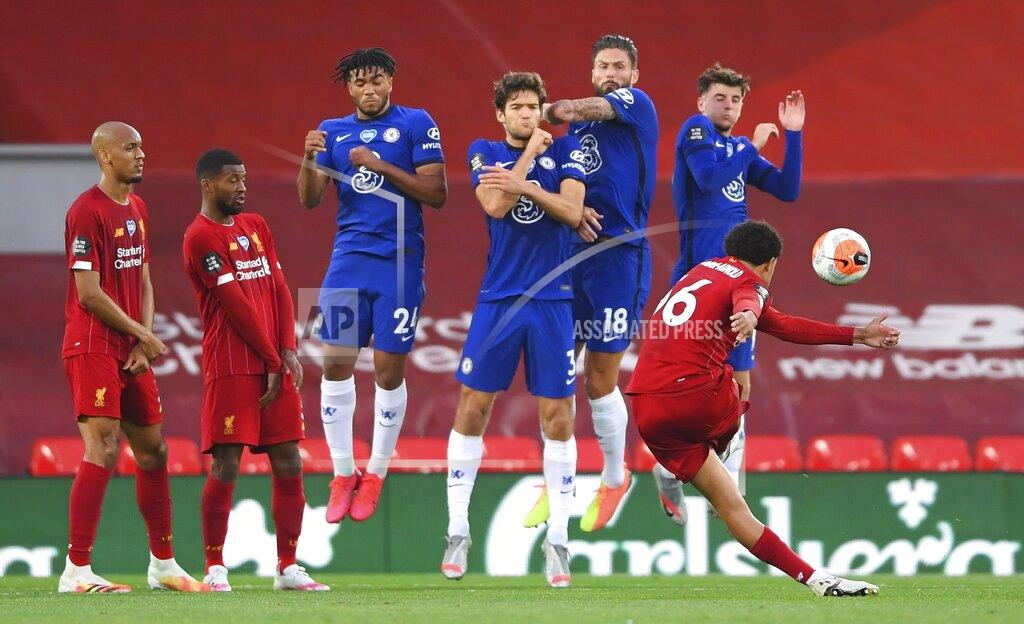 Laurence Griffiths Liverpool's Trent Alexander-Arnold scores his side's second goal from a free-kick during the English Premier League soccer match between Liverpool and Chelsea at Anfield stadium in Liverpool, England, Wednesday, July 22, 2020. (Laurence Griffiths, Pool via AP)
