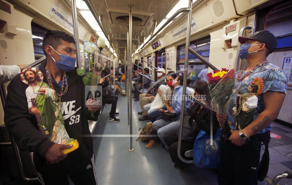 Marco Ugarte Devotees travel on the subway with their Saint Jude statues during the annual pilgrimage honoring Jude, the patron saint of lost causes, in Mexico City, Wednesday, Oct. 28, 2020. Thousands of Mexicans did not miss this year to mark St. Jude's feast day, but the pandemic caused Masses to be canceled and the rivers of people of other years outside the San Hipolito Catholic church were replaced by orderly lines of masked worshipers waiting their turn for a blessing. (AP Photo/Marco Ugarte)