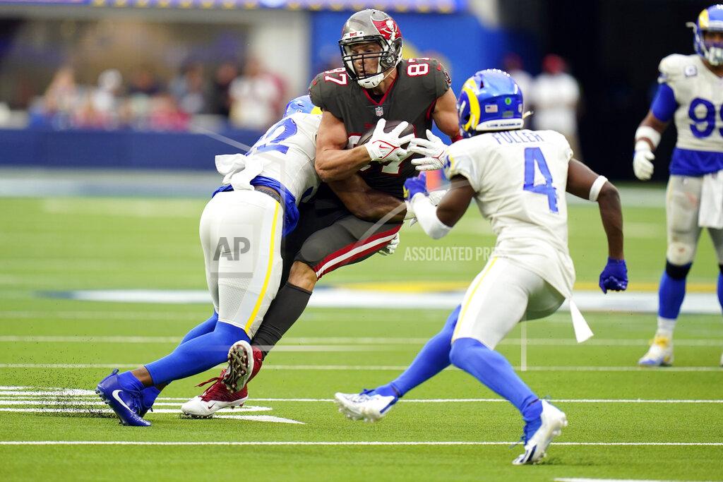 Jae C. Hong Tampa Bay Buccaneers tight end Rob Gronkowski ,center, is tackled by Los Angeles Rams linebacker Terrell Lewis, left, during the second half of an NFL football game Sunday, Sept. 26, 2021, in Inglewood, Calif. (AP Photo/Jae C. Hong)