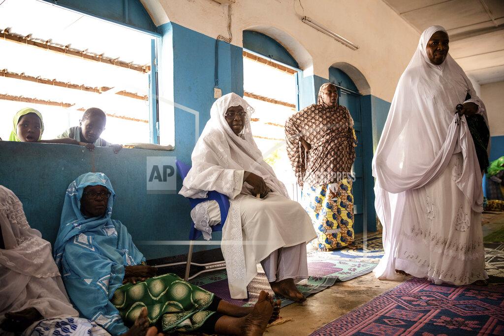 Sophie Garcia Zenabou Coulibaly Zongo, center consultant and founding member of the Council of Burkinabe Women, distributes soap to the mosque in Ouagadougou, Burkina Faso, Friday, Oct. 29, 2021. Zongo spends her own money making soap and buying hand sanitizer for mosques, markets and health centers. At the start of the pandemic, Zongo, now 63, was hospitalized with bronchial pneumonia. She paid out of pocket for two weeks' worth of oxygen treatments at a private clinic, where she watched others die from respiratory problems. (AP Photo/Sophie Garcia)