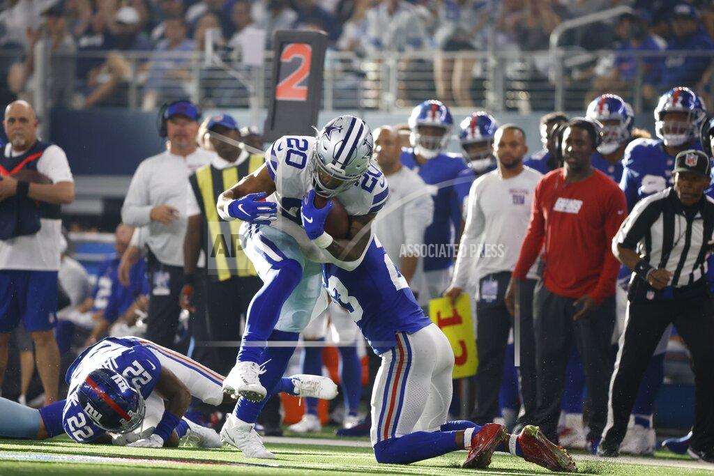 Ron Jenkins Dallas Cowboys running back Tony Pollard (20) is stopped on a running play by New York Giants cornerback Logan Ryan, bottom right, in the second half of an NFL football game in Arlington, Texas, Sunday, Oct. 10, 2021. (AP Photo/Ron Jenkins)