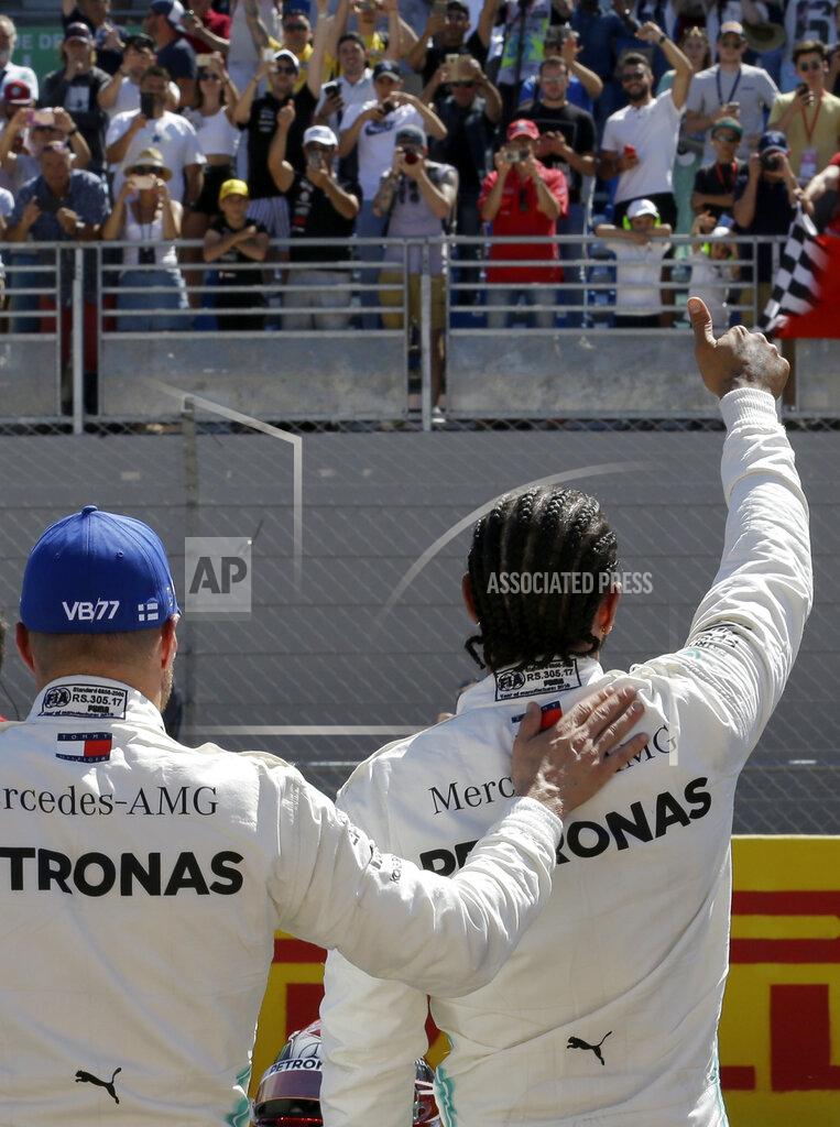 Claude Paris Mercedes driver Lewis Hamilton of Britain, right, who earned pole position, celebrates with Mercedes driver Valtteri Bottas of Finland, who came in second best time after the qualifying session at the Paul Ricard racetrack in Le Castellet, southern France, Saturday, June 22, 2019. The French Formula One Grand Prix will be held on Sunday. (AP Photo/Claude Paris)