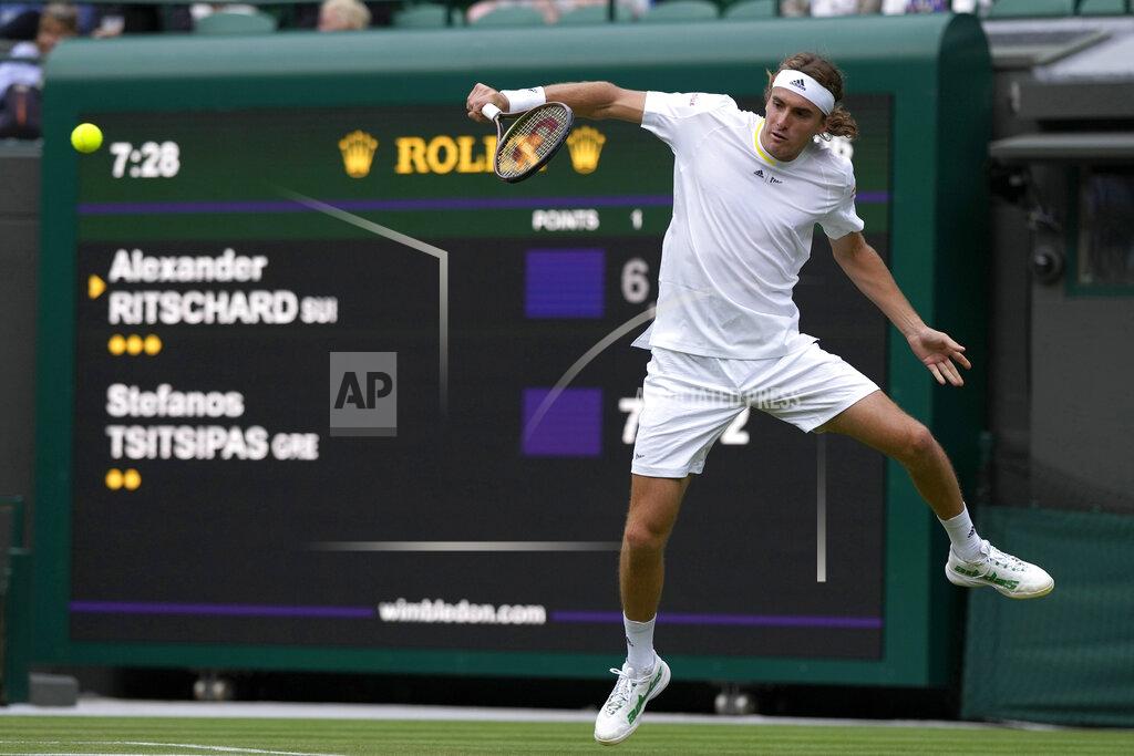 Alastair Grant Greece's Stefanos Tsitsipas returns to Switzerland's Alexander Ritschard during their singles tennis match on day two of the Wimbledon tennis championships in London, Tuesday, June 28, 2022. (AP Photo/Alastair Grant)