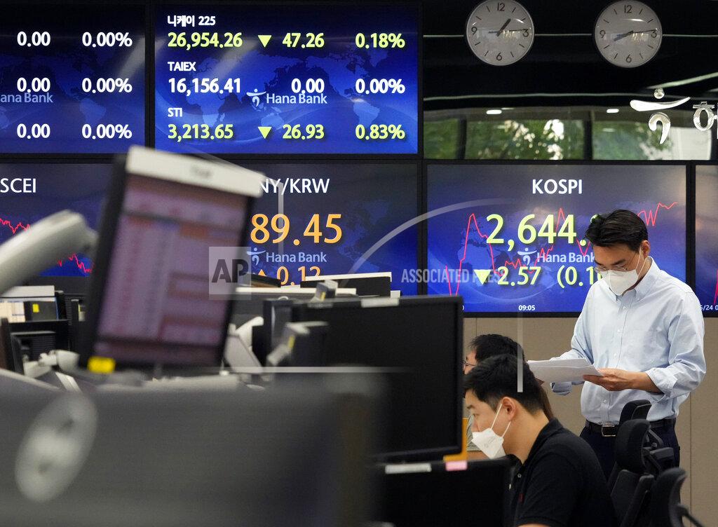 Ahn Young-Joon A currency trader reads documents at the foreign exchange dealing room of the KEB Hana Bank headquarters in Seoul, South Korea, Tuesday, May 24, 2022. Asian shares were mostly lower on Tuesday as worries over inflation tempered optimism over President Joe Biden’s remark that he was considering reducing U.S. tariffs on Chinese imports. (AP Photo/Ahn Young-joon)