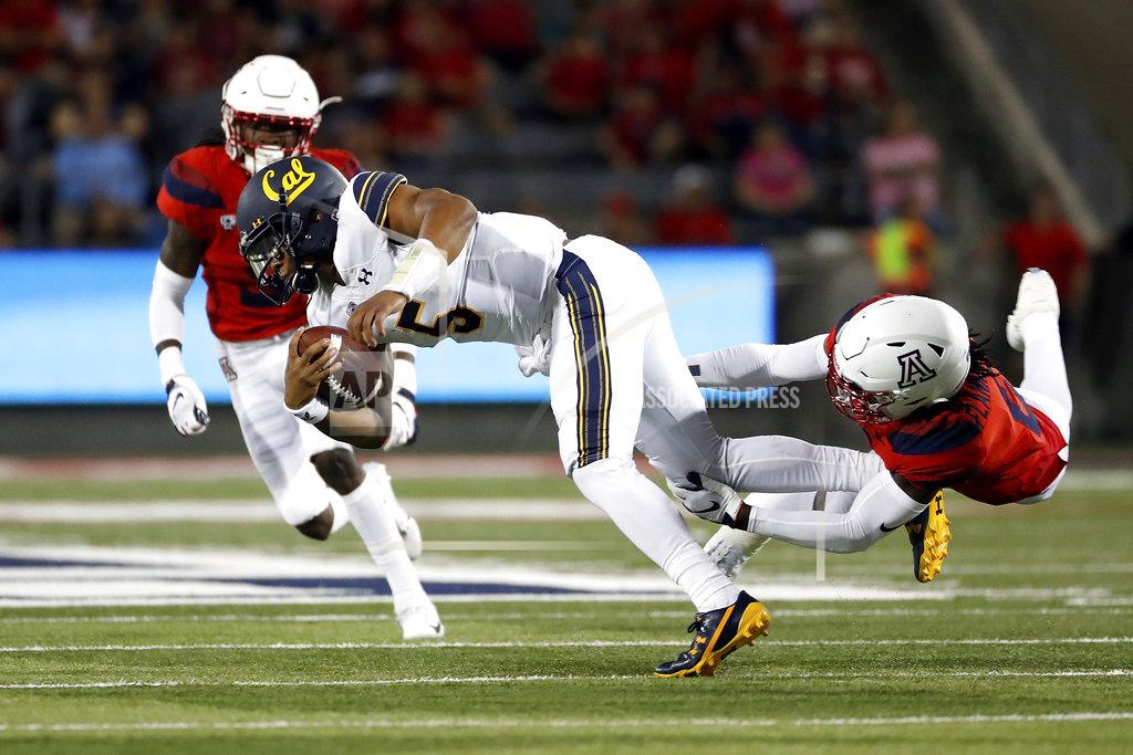 Chris Coduto California quarterback Brandon McIlwain (5) is tackled by Arizona safety Demetrius Flannigan-Fowles (6) during the first half of an NCAA college football game Saturday, Oct. 6, 2018, in Tucson, Ariz. (AP Photo/Chris Coduto)