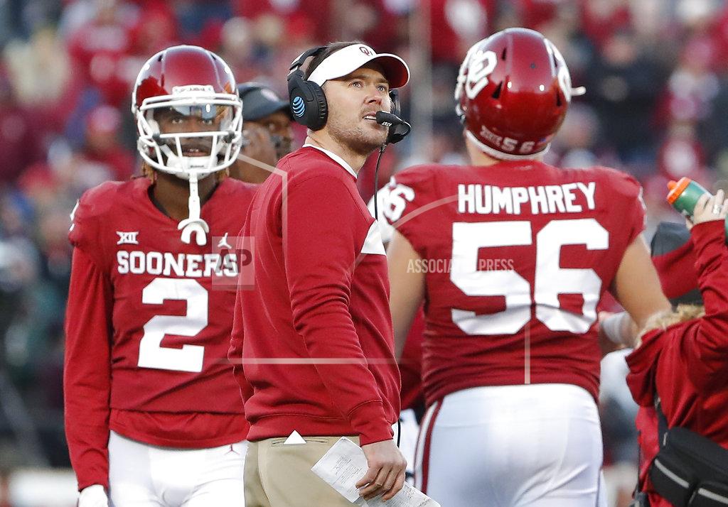 Alonzo Adams Oklahoma head coach Lincoln Riley, center, watches a replay on the video board during a time out against Oklahoma State in the second half of an NCAA college football game in Norman, Okla., Saturday, Nov. 10, 2018. Oklahoma won 48-47. (AP Photo/Alonzo Adams)