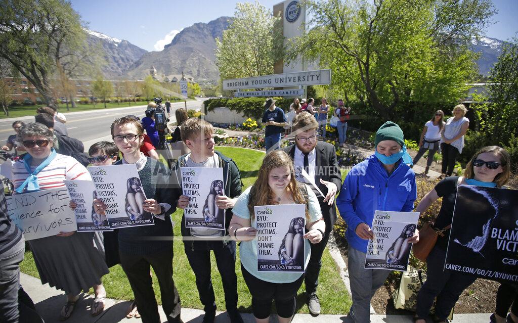 Rick Bowmer FILE - Protesters stand in solidarity with rape victims on the campus of Brigham Young University during a sexual assault awareness demonstration, in Provo, Utah, April 20, 2016. The Biden administration proposed a dramatic overhaul of campus sexual assault rules on Thursday, June 23, 2022, acting to expand protections for LGBTQ students, bolster the rights of victims and widen colleges' responsibilities in addressing sexual misconduct. (AP Photo/Rick Bowmer, File)