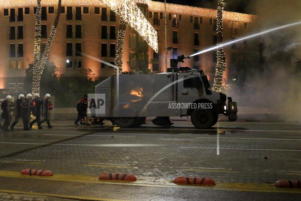 Hektor Pustina A police water cannon operates against protesters during clashes in Tirana, Friday, Dec. 11, 2020. Albanian demonstrators clashed in the third day on Friday protesting for the death of a 25-year-old man shot dead by a police officer. (AP Photo/Hektor Pustina)