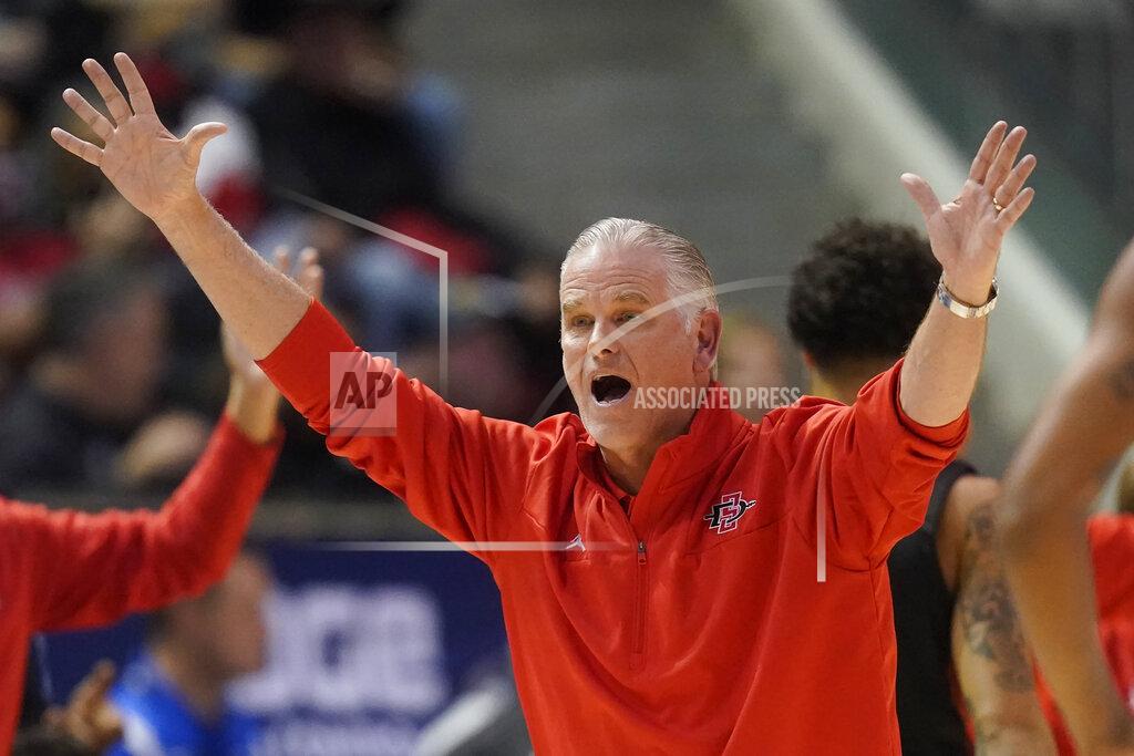 Rick Bowmer FILE - San Diego State coach Brian Dutcher reacts after a call during the first half of the team's NCAA college basketball game against BYU on Nov. 12, 2021, in Provo, Utah. Three decades after Brian Dutcher was the lead recruiter who signed Juwan Howard at Michigan, the two will oppose each other as coaches on Saturday. Dutcher brings his San Diego State team into Ann Arbor to face the Wolverines, who are in their third year under Howard, who was the first of the fabled Fab Five to sign with Michigan. (AP Photo/Rick Bowmer, File)