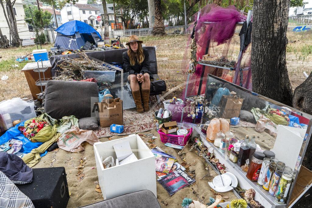 Dawn Woodward Dawn Woodward, 39, who is homeless and originally from Arizona, sits outdoors in a homeless camp on the side of the CA-101 highway in Echo Park neighborhood in Los Angeles Tuesday, May 11, 2021. California Gov. Gavin Newsom on Tuesday proposed $12 billion in new funding to get more people experiencing homelessness in the state into housing and to “functionally end family homelessness” within five years. (AP Photo/Damian Dovarganes)