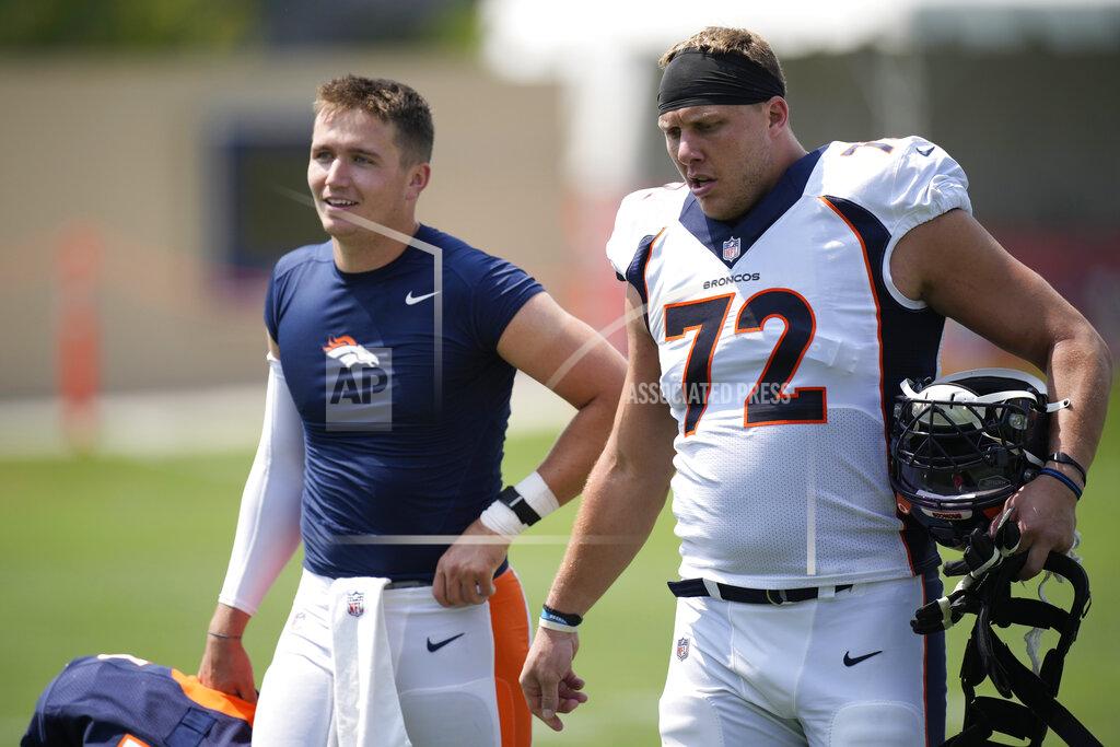 Denver Broncos quarterback Drew Lock, left, and offensive tackle Garett Bolles talk as they head to the locker room after taking part in drills at an NFL football training camp practice Tuesday, Aug. 3, 2021, at team headquarters in Englewood, Colo. (AP Photo/David Zalubowski)
