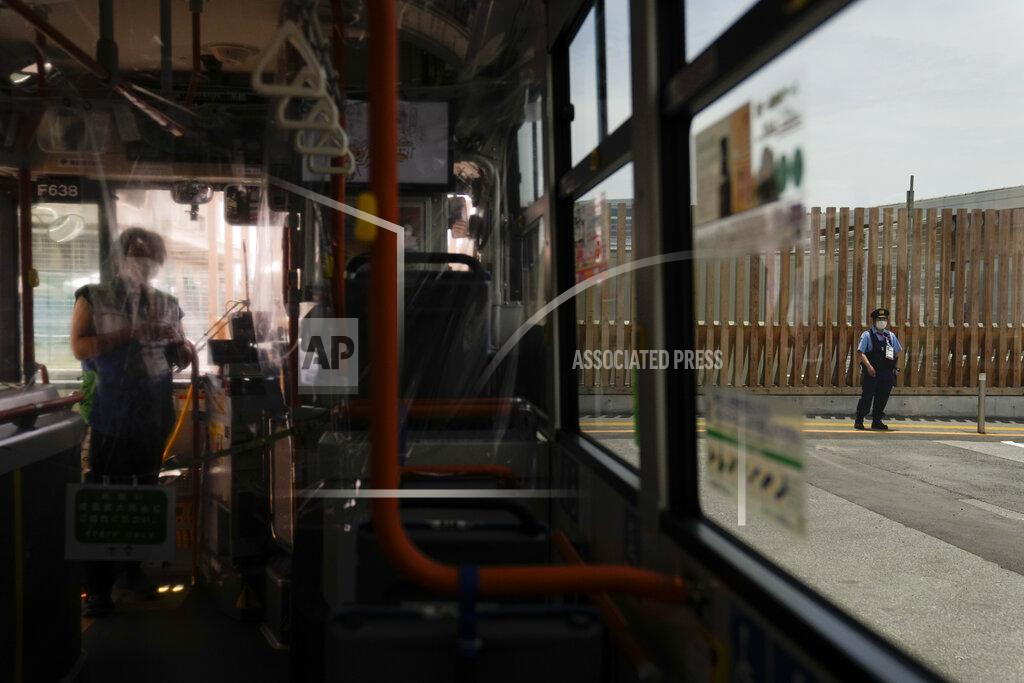 Jae C. Hong A police officer, right, patrols near the entrance to the athlete's village for the 2020 Summer Olympics and Paralympics, Thursday, July 15, 2021, in Tokyo. (AP Photo/Jae C. Hong)