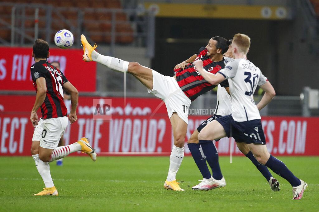Antonio Calanni AC Milan's Zlatan Ibrahimovic controls the ball by Bologna's Jerdy Schouten during the Serie A soccer match between AC Milan and Bologna at the San Siro stadium, in Milan, Italy, Monday, Sept. 21, 2020. (AP Photo/Antonio Calanni)