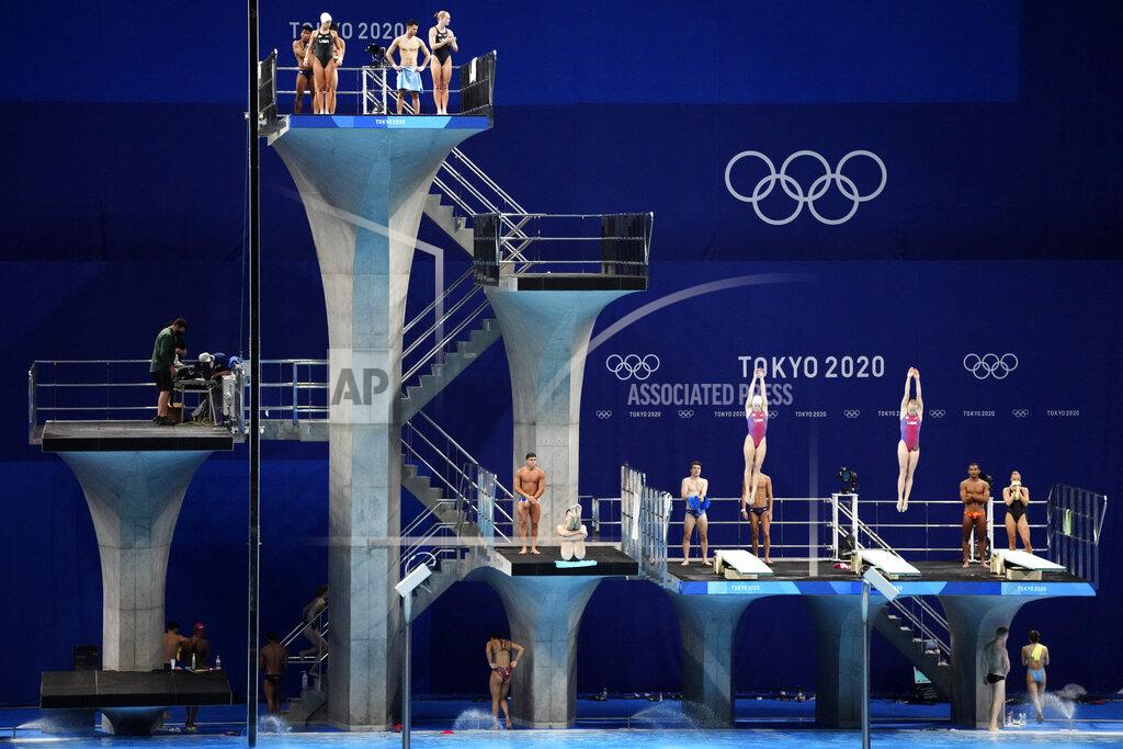 FILE - In this July 21, 2021 file photo, athletes practice during a diving training session at the Tokyo Aquatics Centre at the 2020 Summer Olympics, in Tokyo, Japan. The Tokyo Aquatics Centre is a site to behold -- a towering, 15,000-seat venue that will host swimming and diving at the pandemic-delayed Summer Games. (AP Photo/Matthias Schrader,File)