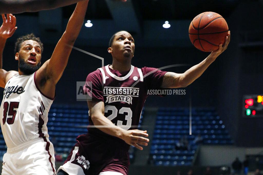 Rogelio V. Solis Mississippi State guard Tyson Carter (23) attempts a layup past New Mexico State forward Johnny McCants (35) during the second half of an NCAA college basketball game, Sunday, Dec. 22, 2019, in Jackson, Miss. (AP Photo/Rogelio V. Solis)