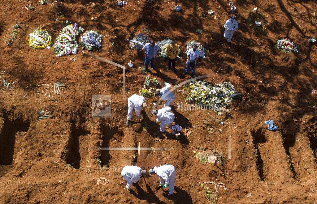 Andre Penner FILE - In this May 20, 2020, file photo, cemetery workers in protective clothing bury a COVID-19 victim at the Vila Formosa cemetery in Sao Paulo, Brazil. Even amid a global pandemic, there’s no sign that corruption is slowing down in Latin America. In Brazil, which has the world's second-highest number of confirmed cases, police created a task force to investigate crimes tied to the pandemic. (AP Photo/Andre Penner)