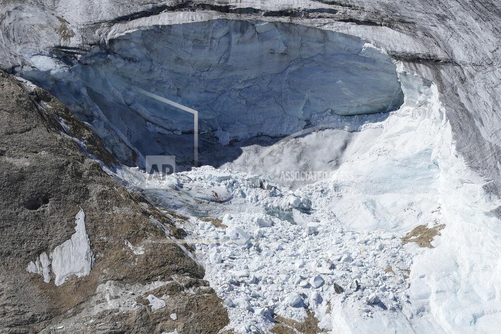 Luca Bruno A view taken from a rescue helicopter of the Punta Rocca glacier near Canazei, in the Italian Alps in northern Italy, Tuesday, July 5, 2022, two day after a huge chunk of the glacier broke loose, sending an avalanche of ice, snow, and rocks onto hikers. (AP Photo/Luca Bruno)