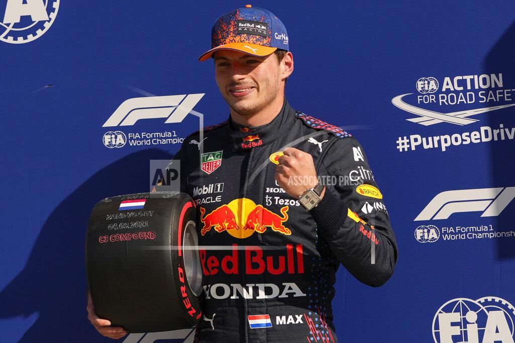 Francisco Seco Red Bull driver Max Verstappen of the Netherlands celebrates clinching the pole position after the qualifying session for Sunday's Formula One Dutch Grand Prix at the Zandvoort racetrack, Netherlands, Saturday, Sept. 4, 2021. (AP Photo/Francisco Seco, Pool)
