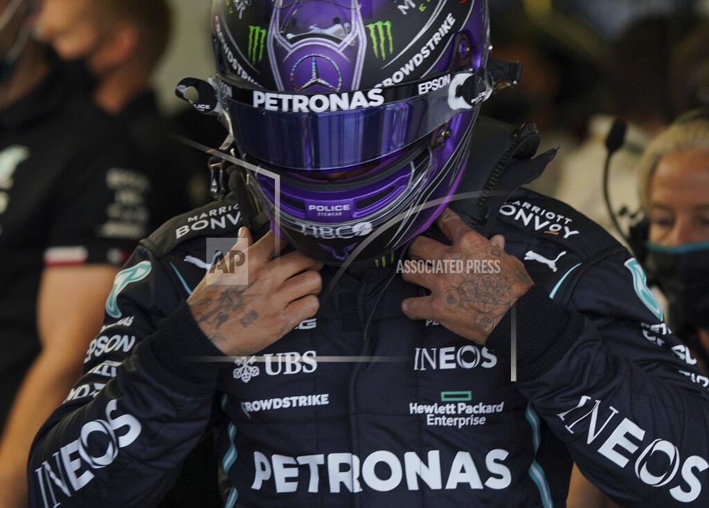 Fernando Llano Formula One Mercedes driver Lewis Hamilton, of Britain, adjusts his helmet prior to a practice session ahead of this weekend's Mexican Grand Prix in Mexico City, Friday, Nov. 5, 2021. (AP Photo/Fernando Llano)