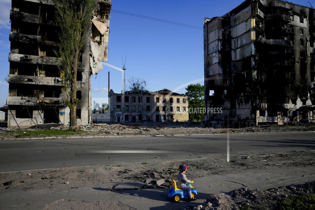 Natacha Pisarenko A boy plays in front of houses ruined by shelling in Borodyanka, Ukraine, Tuesday, May 24, 2022. (AP Photo/Natacha Pisarenko)