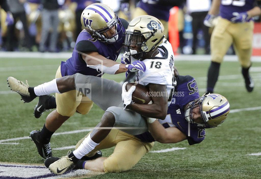 Ted S. Warren Colorado wide receiver Tony Brown (18) is tackled by linebacker Ben Burr-Kirven, right, and linebacker Joe Tryon, left, during the second half of an NCAA college football game, Saturday, Oct. 20, 2018, in Seattle. Washington won 27-13. (AP Photo/Ted S. Warren)