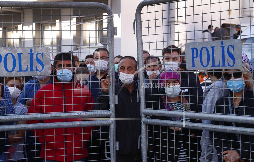 Darko Bandic Local residents watch as medics and rescue personnel carry into an ambulance an injured person from the debris of a collapsed building in Izmir, Turkey, Saturday, Oct. 31, 2020. Rescue teams on Saturday ploughed through concrete blocs and debris of eight collapsed buildings in Turkey's third largest city in search of survivors of a powerful earthquake that struck Turkey's Aegean coast and north of the Greek island of Samos, killing dozens Hundreds of others were injured. (AP Photo/Darko Bandic)