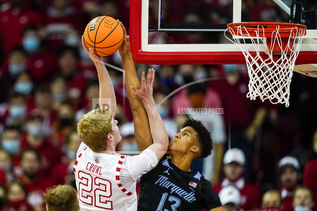Andy Manis Marquette's Oso Ighodaro (13) blocks Wisconsin's Steven Crowl (22) during the first half of an NCAA college basketball game Saturday, Dec. 4, 2021, in Madison, Wis. (AP Photo/Andy Manis)