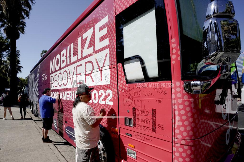 Rich Pedroncelli Sa Thao signs the 2022 Mobile Recovery National Bus during a stop at the Capitol in Sacramento, Calif. Sept. 7, 2022. Across the country, people in recovery and relatives of those killed by opioid overdoses are pressing for roles in determining how billions in opioid settlement money will be used. That push is one of the missions of the monthlong nationwide bus tour. Thao was addicted to methamphetamine but through recovery programs has been clean for 18 months. (AP Photo/Rich Pedroncelli)