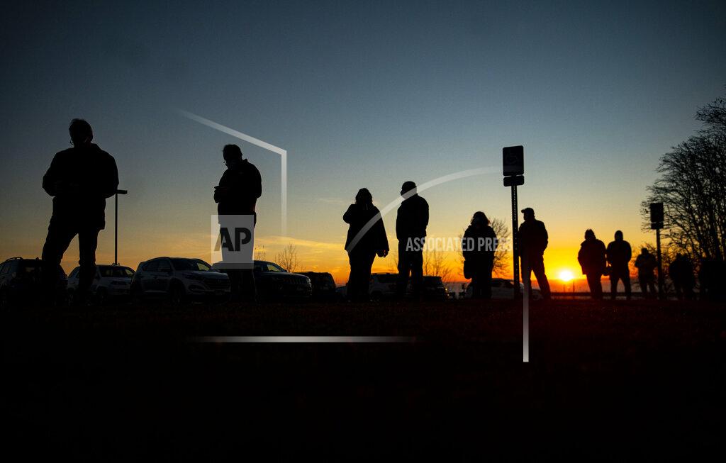 Alex Kormann A long line of voters forms outside of First United Methodist Church as the sun rose over Lake Superior in Duluth, Minn., on Election Day, Tuesday, Nov. 3, 2020. (Alex Kormann/Star Tribune via AP)