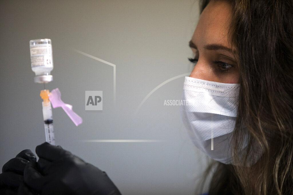 RN Lauren Dean fills syringes with the Moderna COVID-19 vaccine inside of the pharmacy at the Hamilton County Health Department's new COVID Vaccination POD at the CARTA Bus Terminal on Thursday, Jan. 28, 2021 in Chattanooga, Tenn. (Troy Stolt/Chattanooga Times Free Press via AP)
