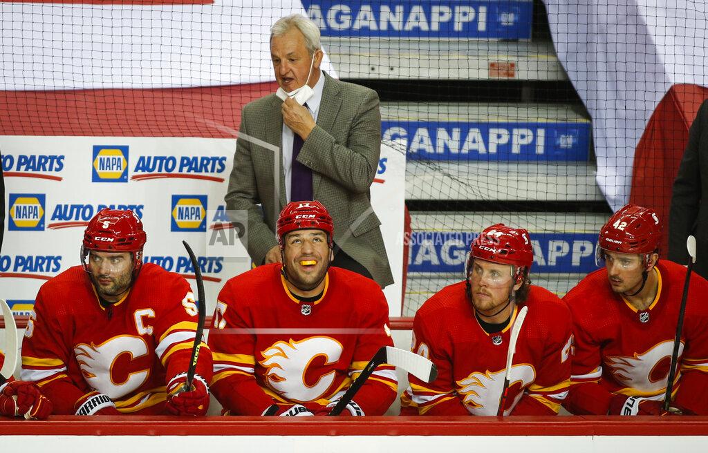 Jeff Mcintosh Calgary Flames' head coach Darryl Sutter instructs his players during second period of an NHL hockey game against the Vancouver Canucks in Calgary, Alberta Thursday, May 13, 2021. (Jeff McIntosh/The Canadian Press via AP)