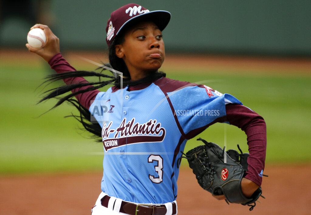 FILE - In this Aug. 15, 2014, file photo, Pennsylvania's Mo'ne Davis delivers in the fifth inning against Tennessee during a baseball game at the Little League World Series tournament in South Williamsport, Pa. There are cities defined by their signature sporting events. “This is who we are,” said Jason Fink, the chamber of commerce president in Williamsport, Pennsylvania, which has been synonymous with the Little League World Series since it was founded in 1947. (AP Photo/Gene J. Puskar, File)