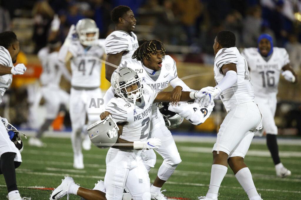 Memphis players T.J. Carter (2), Cameron Fleming, center, and Kendell Johnson, right, celebrate at the end of the game after defeating Tulsa 42-41 in an NCAA college football game in Tulsa, Okla., Saturday, Oct. 26, 2019. (AP Photo/Sue Ogrocki)