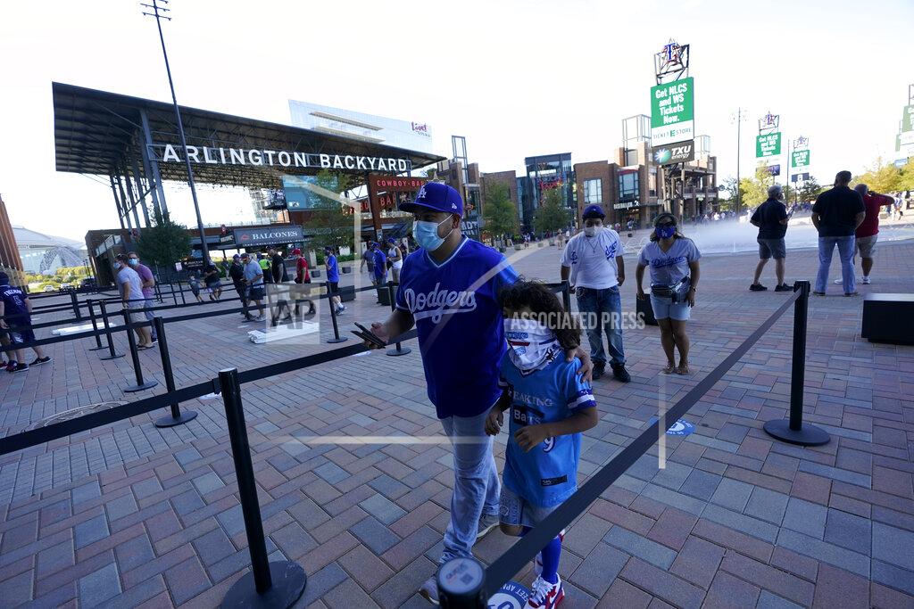 Eric Gay Fans arrive before Game 1 of a baseball National League Championship Series between the Los Angeles Dodgers and the Atlanta Braves Monday, Oct. 12, 2020, in Arlington, Texas. (AP Photo/Eric Gay)